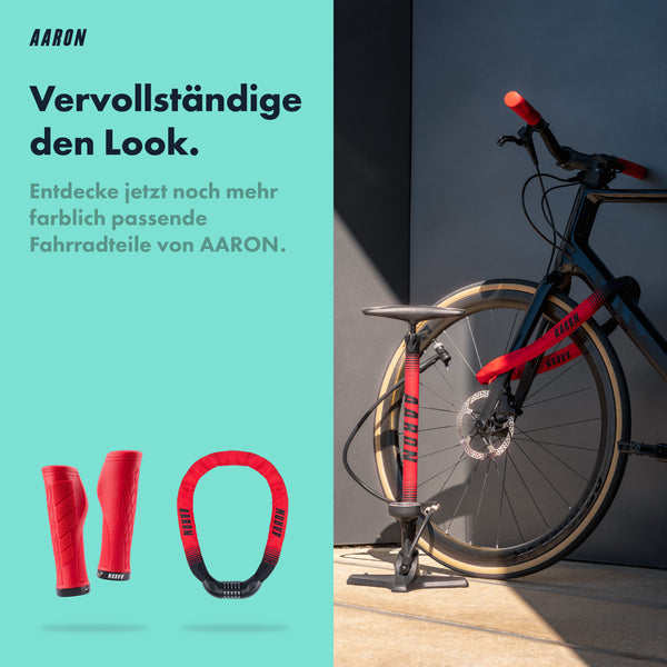 AARON Sport One Fahrradpumpe - Rot neben einem Fahrrad mit rotem Griff und schwarzem Rahmen für vielseitiges Aufpumpen.